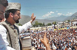 Mirwaiz Umar Farooq, Chairman of the All Parties Hurriyat Conference, waves to the crowd after laying a wreath of flowers on the grave of his ancestor Mirwaz Moulana Mohammah Yousaf Shah in Muzaffarabad, on Friday.