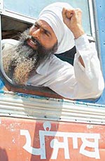 A farmer raising slogans against the Punjab Government after being arrested at Kathu Nangal on Friday.