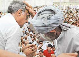 An elderly villager blesses Haryana Chief Minister Bhupinder Singh Hooda after he won the Kiloi Assembly seat on Sunday.