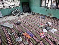 Books and shoes of schoolchildren lie scattered in a classroom after an explosion in Pulwama, 39 km south of Srinagar