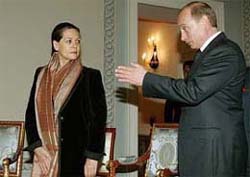 Russian President Vladimir Putin gestures as he invites Congress President Sonia Gandhi for negotiations at Konstantinovsky Palace