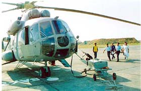 Air Force men carry Canadian citizen Ruth Norfolk, rescued from mountains near Dharamsala, at the Pathankot air base
