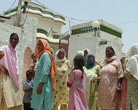 Women gather outside the house of Amarjit Kaur, Sarpanch of Malkana village, following her murder on Saturday.