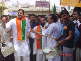BJP workers beat tin containers during a protest march against the Congress government and local Municipal Council in Abohar