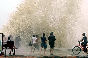 Children enjoy being lashed by huge waves at Worli Sea Face in Mumbai on Wednesday.