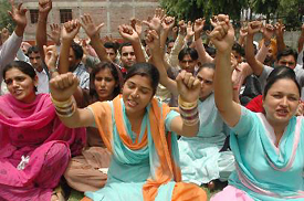 Members of the Unemployed Elementary Teachers Union stage a dharna to demand regular employment for ETT teachers in Jalandhar on Tuesday.