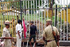 Security personnel stand guard while workers on Wednesday carry out repair and maintenance work on the outer barricade which the militants attempted to blow-up in a bid to enter the makeshift Ram temple in Ayodhya on Tuesday.