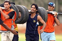 Ajit Agarkar, Dinesh Kartik and Rahul Dravid during the ongoing fitness and conditioning camp at the Chinnaswamy Stadium in Bangalore on Saturday.