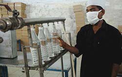 One-litre bottles being packaged at one of the bottling units in the region. Though most local bottling units fill the bottles manually, the changeover to a mechanised set-up is under way and there is a time-frame stipulated by the BIS.