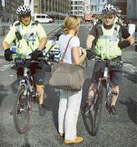 Policemen give directions to pedestrians as they block Ludgate Hill near St. Pauls Cathedral in London on Thursday after a suspect package was found in the area but not deemed a threat.