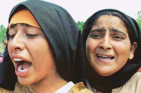 Relatives cry over the death of three teenaged boys at Bagargund village, 105 km north of Srinagar, on Sunday.
