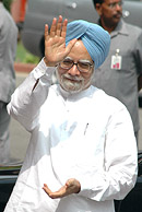 Prime Minister Manmohan Singh waves to photographers as he arrives for the opening of the monsoon session of Parliament in New Delhi on Monday.