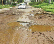 Puddles of water formed in craters on the Nawanshahr- Samrala road. 