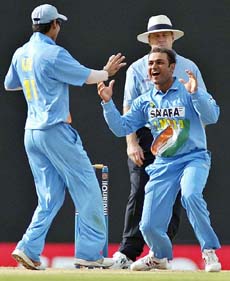 Virender Sehwag and Mohammed Kaif celebrate the dismissal of West Indies batsman Narsing Deonarine during the one-day international tri-series match between India and the West Indies at Dambulla, Sri Lanka, on Sunday.
