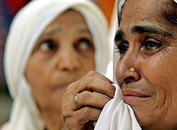 Relatives of victims of the 1984 anti-Sikh riots weep during a protest in New Delhi on Tuesday. 