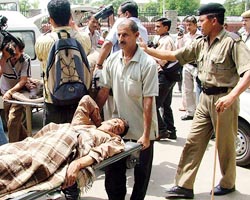 A person injured in an attack by militants on a family in Shehjru village of Udhampur district is taken to hospital in Jammu on Saturday.