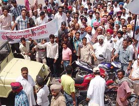 Activists of various social and political bodies block traffic at the Joginder Singh Chowk in Moga