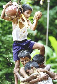 Visually challenged children form a human pyramid as they try to break a clay pot containing butter during Janmashtami celebrations in Mumbai on Friday