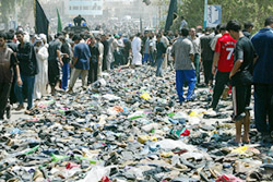 Iraqis walk among shoes lost during a stampede on a bridge in Baghdad on Wednesday.