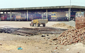 Trucks parked inside Grain Market in Bathinda. Construction material lying in the market can also be seen.