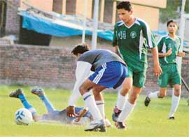 Players in action during the Chandigarh Junior Challenge Football Cup Tournament being played at Sports Complex, Sector 42, Chandigarh, on Friday.