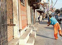 Children play cricket in front of closed shops during a bandh in Jalandhar on Saturday. 