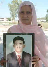 Murti Devi, claiming to be the wife of Daya Ram, holds a photograph of her husband taken about 38 years ago at Vidya Sagar Mental Hospital in Amritsar on Friday.