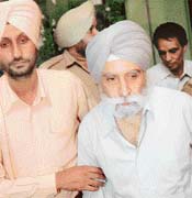 Technical Education Deputy Director N.S. Bhatia is led away by the Vigilance Bureau after he was caught while allegedly accepting a bribe in Chandigarh on Wednesday