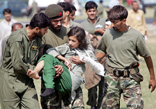 An injured Kashmiri girl is carried as she arrives at a military base after she was transferred from an earthquake-affected area of Pakistan in Rawalpindi on Wednesday