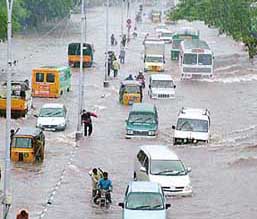 Vehicles move through a flooded road in Chennai on Thursday after heavy rain lashed the city.
