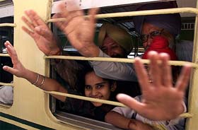 Sikh pilgrims wave from train to Pakistan at Amritsar Railway Station