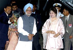 Prime Minister Manmohan Singh poses with Bangladeshi Prime Minister Khaleda Zia after arriving for the 13th SAARC Summit at Zia International Airport, Dhaka