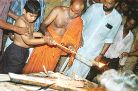 Eight-year-old Ajay, the eldest son of Maniappan Kutty, the slain BRO employee, performs the last rites at the funeral of his father at Chingoli village on Friday.