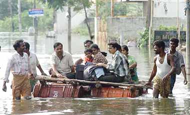 Residents are transported by a makeshift raft in Chennai on Sunday. Cyclone Baaz, which was hovering in the Bay of Bengal, weakened into a depression  but brought rain to drench the southern metropolis.