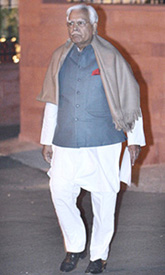Mr Natwar Singh stands outside the Prime Minister residence after handing over his resignation in New Delhi on Wednesday.