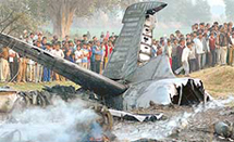 Villagers look at a Canberra bomber which crashed near Agra on Monday