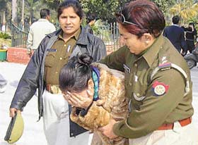 A woman police official drags a girl at Gandhi Park in Meerut during Operation Majnu