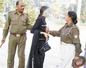 Another woman official pushes a girl during the same operation