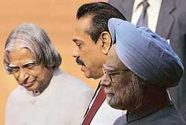 Sri Lankan President Mahinda Rajapakse speaks with President APJ Abdul Kalam and Prime Minister Manmohan Singh after inspecting a guard of honour at Rashtrapati Bhavan in New Delhi, on Wednesday.