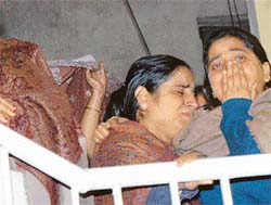 Relatives of Prof M.C. Puri, who was killed in Bangalore on Wednesday, console each other as the body reaches his Mount Kailash house in New Delhi