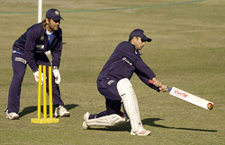 Sachin Tendulkar plays a shot as team-mate Mahendra Singh Dhoni looks on during a practice session at the Gaddafi Stadium in Lahore on Friday. India open their tour with a three-day match against Pakistan A beginning on Saturday. 
