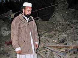 Shah Zaman, who lost his three children, walks on the rubble of his house, destroyed in an apparent pre-dawn air strike in Damadola, about 200 km northwest of Islamabad