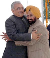 Mr H.S. Chatha hugs Haryana Chief Minister Bhupinder Singh Hooda after being inducted into the Cabinet in Chandigarh