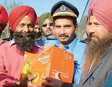 Drivers of the Amritsar-Lahore bus, Punj-Aab, present sweets to M. Yaseem, driver of the Lahore-Amritsar bus, in Amritsar on Saturday