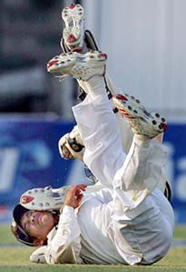 Sachin Tendulkar and Mohammad Yousuf (rear) fall to the ground after colliding with each other while Yousuf was taking a run on the second day of the third and final Test in Karachi on Monday. Tendulkar did not take the field again till stumps.