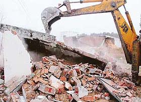 A JCB removes illegal structures at Kishangarh in Chandigarh