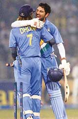 Yuvraj Singh hugs master-blaster Mahendra Singh Dhoni after India beat Pakistan by five wickets in the third one-day international in Lahore on Monday