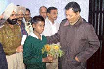 The Deputy Commissioner, Mr Alok Shekhar, presents a bouquet to Asif prior to his repatriation in Faridkot on Monday.