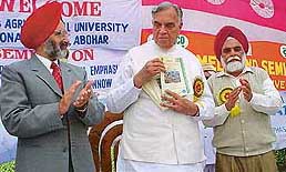 The Governor of Madhya Pradesh, Dr Bal Ram Jakhar, releases a souvenir of Punjab Agricultural University at its regional station in Abohar on Thursday.
