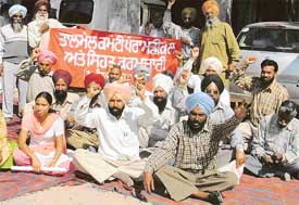 Paramedical and health employees stage a dharna at the office of the Civil Surgeon in Ludhiana on Thursday